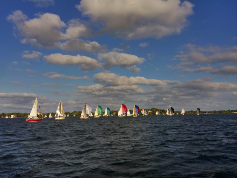 Sailboats racing on Lake Minnetonka under scattered clouds