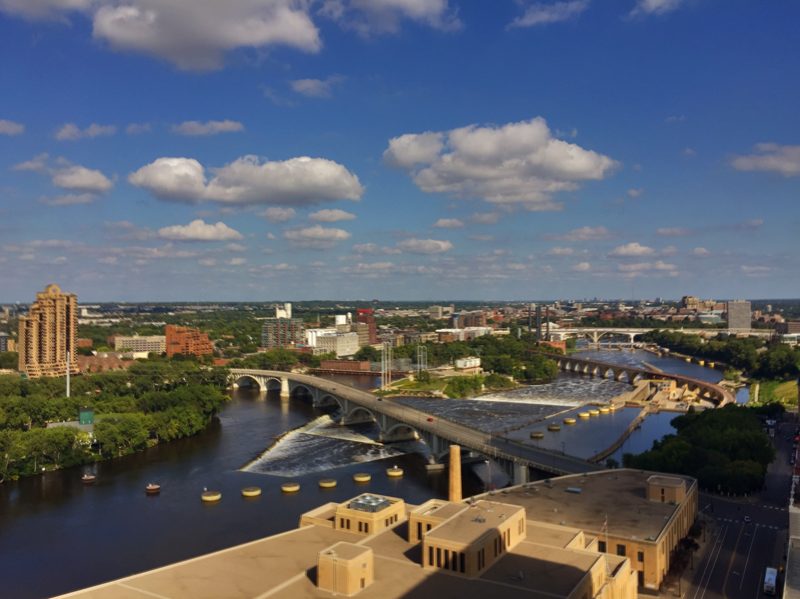 Aerial view of the Mississippi River at St. Anthony Falls with the lock, dam, bridges, and the historic mill district